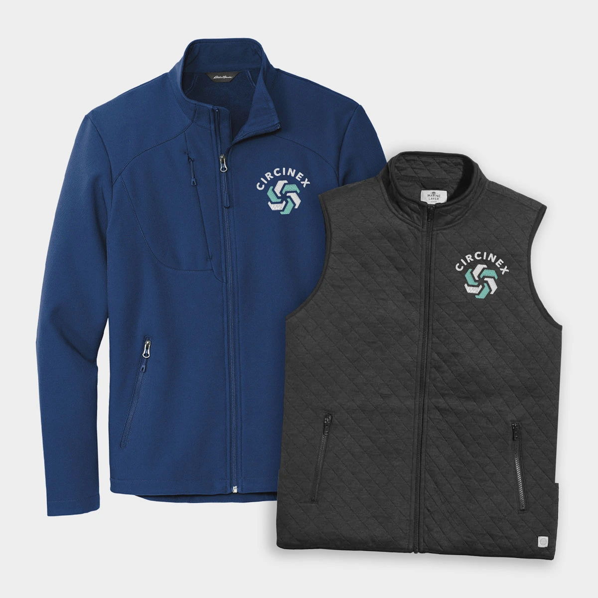 A zip-up jacket and vest lay side by side