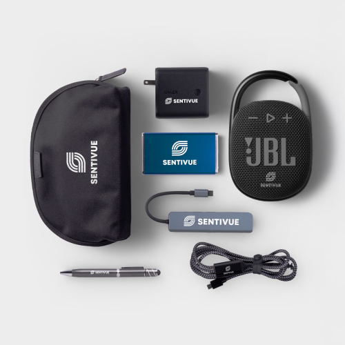 A bluetooth speaker, portable chargers, and a stylus are arranged together